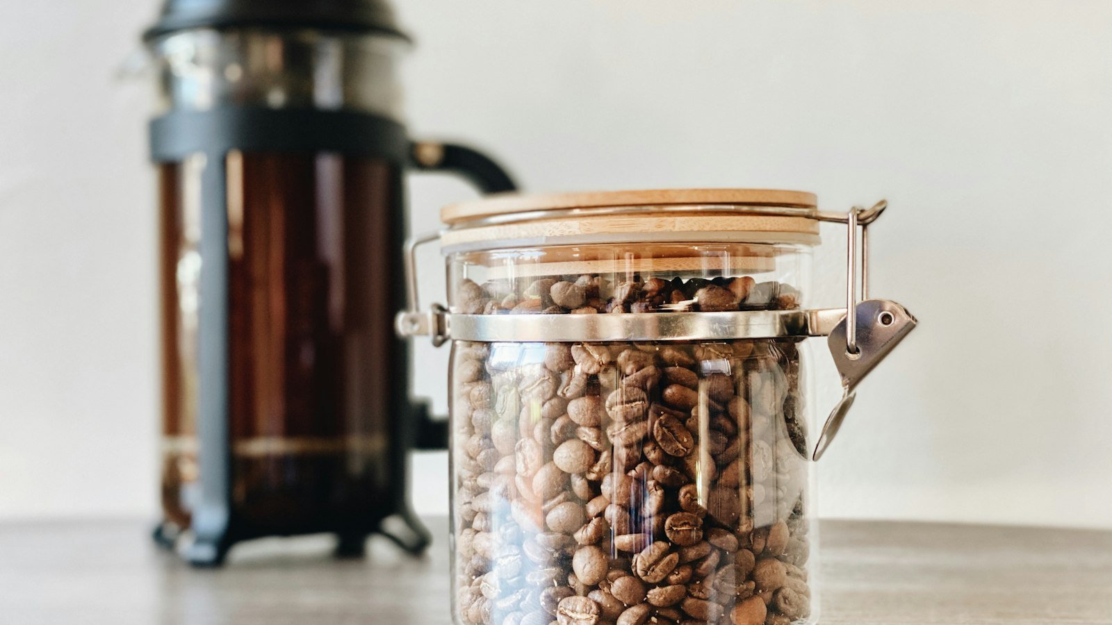 French press and a jar of coffee beans
